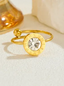 Macro shot of rose gold ring featuring Roman numeral engraving and a center zircon stone