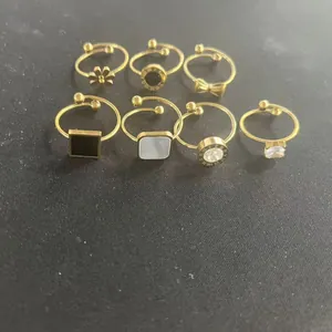 7-piece set of gold-toned rings featuring Roman numerals, flowers, and geometric patterns