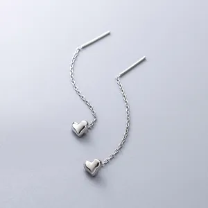 Sleek silver heart tassel drop earrings featuring polished heart pendants on delicate chains
