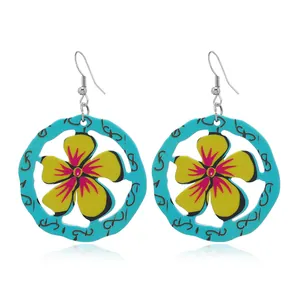 Ethnic style turquoise blue circular earrings with yellow floral motifs and black script