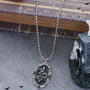 Gothic style oval snake pendant necklace with black relief and silver beaded chain