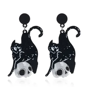 Gothic black cat and skull acrylic drop earrings with celestial patterns on white background