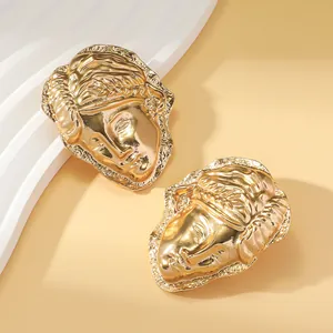 Detailed view of vintage gold metal earrings featuring exquisite portrait relief design