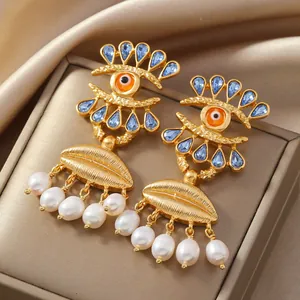 Boucles d'oreilles élégantes avec perles, œil en cristal bleu et accents dorés