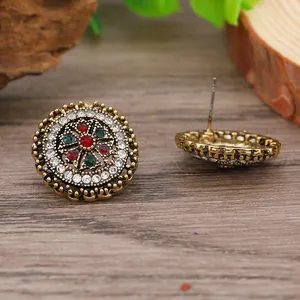 Macro shot of vintage alloy earrings with colorful rhinestones and ornate metalwork