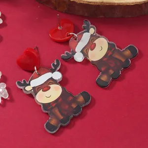 Christmas earrings featuring cute acrylic reindeer with heart studs on a festive red background