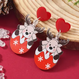 Close-up of cute Christmas reindeer acrylic earrings on a rustic wood background