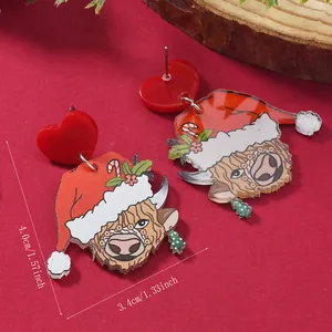 Christmas Highland cow earrings with red heart studs and dimensions on wood tray