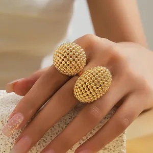 Vue détaillée d'une bague plaquée or avec des éléments texturés sphériques et ovales