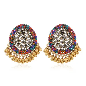 Macro detail of Bohemian round drop earrings with colorful rhinestones and gold beads