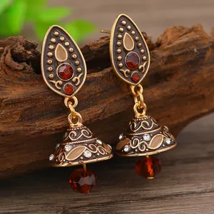 Vintage bohemian bronze bell earrings with red gemstone and intricate floral enamel detail