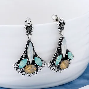 Classic teardrop earrings with vintage silver finish and vibrant faceted gemstones