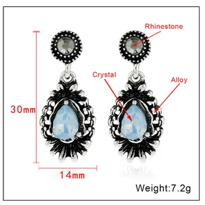 Detailed view of silver water drop earrings with blue crystal and rhinestone accents
