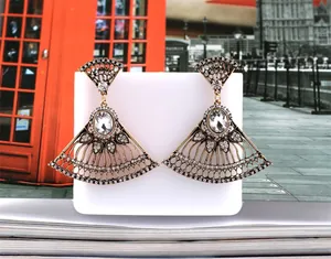 Detail of fan-shaped vintage dangle earrings with crystal rhinestones on a bronze base