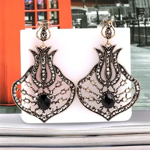 Detail view of vintage fan-shaped tulip earrings with grey rhinestones and black gem