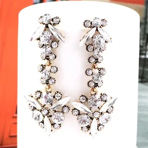 Detailed close-up of vintage fan-shaped long tassel earrings with sparkling zircon stones