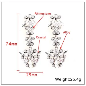 Detailed view of silver-tone tassel earrings with 74mm length and crystal embellishments