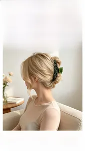 Deep green flower hair claw clip with crystal details shown in an elegant updo hair style