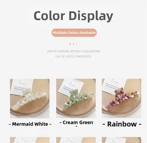 Detail view of acetate flower hair claws in pearl white, cream green and glitter colors