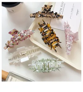 Detail shot of elegant acetate claw clips in floral and leopard prints for women