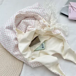 Internal view of polka dot canvas bag with lace detailing and inner zipper pocket