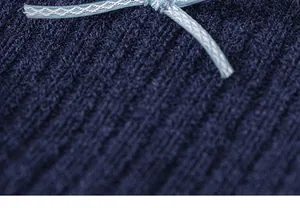 Close-up of navy blue knitted fabric with a light blue bow detail for girls' tops