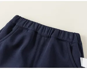 Close-up detail of the comfortable elastic waistband on dark navy children's cotton pants