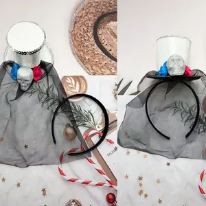 Detail of mini witch hat headband with veil, skull, flowers and silver sequins