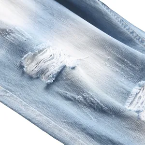 Light blue distressed denim shorts with ripped details and a washed vintage finish