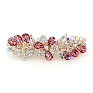 Elegant rose gold flower hair clip with pink crystals and rhinestones on white background