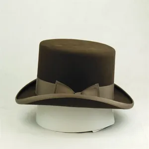 Classic dark brown wool felt top hat with khaki ribbon bow on a white display stand