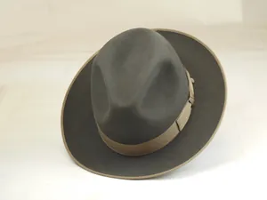 Detail of grey wool fedora hat featuring a khaki grosgrain ribbon and bound edge