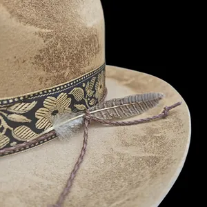 Close-up of vintage wool felt fedora with floral embroidery and natural feather accent