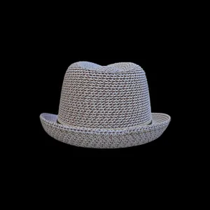 Detailed close-up of woven straw hat texture with two-tone beige and brown braiding