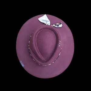 Detail of dark purple wool fedora featuring leopard print ribbon and white hand stitching