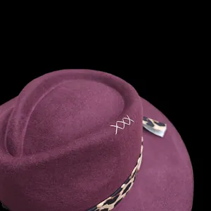 Detail of wool fedora with leopard print ribbon and silver embroidered cross stitching