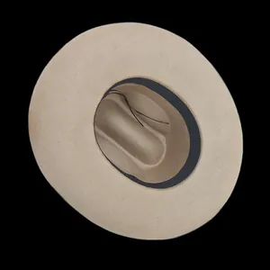 Detail view of the elegant beige wool fedora interior with black sweatband and adjustable strap