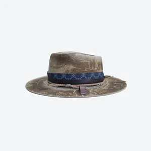 Close-up of vintage wool fedora featuring distressed texture and multilayered ribbon bands