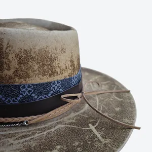 Close-up of vintage wool felt fedora with distressed texture and multi-layer decorative bands