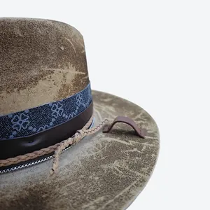 Detail of vintage wool felt fedora featuring distressed texture and clover ribbon band