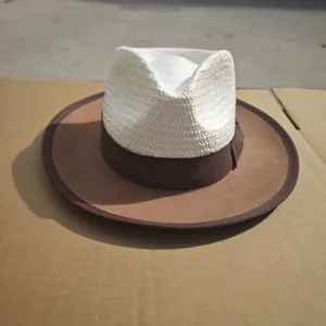 Detail of Panama style hat showing white straw weave crown and brown felt brim texture