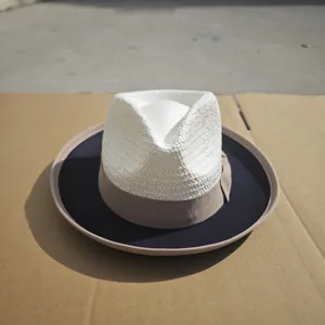 Detailed close-up of a stylish two-tone wool felt fedora with straw weave texture