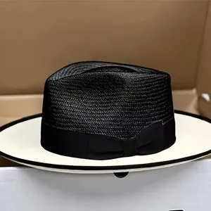 Contrast panama fedora hat with black straw crown and white brim in a storage box