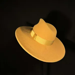 Detail of a bright yellow wool fedora hat with wide brim and matching satin ribbon
