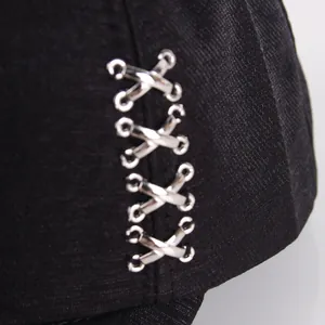 Black hip hop baseball cap with silver metal X-shaped cross ring hardware details