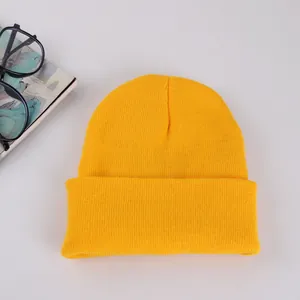 Bright yellow ribbed knit beanie hat with a folded cuff for winter warmth and comfort