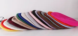 Flat lay display of colorful wool beret hats for girls in multiple vibrant shades