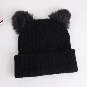 Black knit beanie with large faux fur cat ears on a clean white background