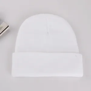 Detailed texture of white ribbed knit beanie with turn-up cuff for winter warmth