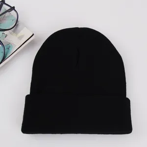 Detailed view of black knitted beanie with cuffed edge and fine ribbed texture pattern